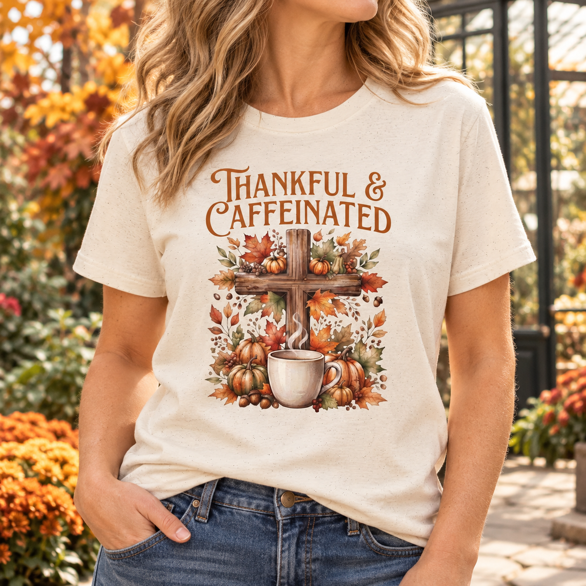 Natural Thankful & Caffeinated Shirt — faceless female chest close-up neck to hips near a botanical conservatory with autumn foliage