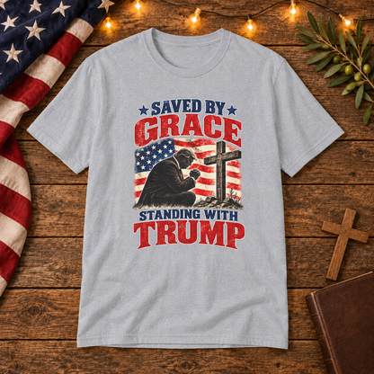 Saved by Grace Standing with Trump Shirt | Christian Patriotic T-Shirt | Unisex Tee — Christian American wooden background