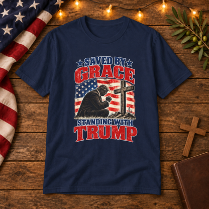 Saved by Grace Standing with Trump Shirt | Christian Patriotic T-Shirt | Unisex Tee — Christian American wooden background