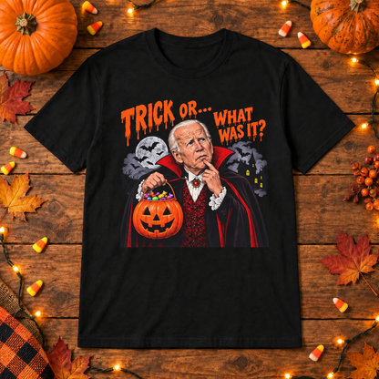 Black Joe Biden vampire trick or shirt on a wooden background with Halloween lights, pumpkins and candy