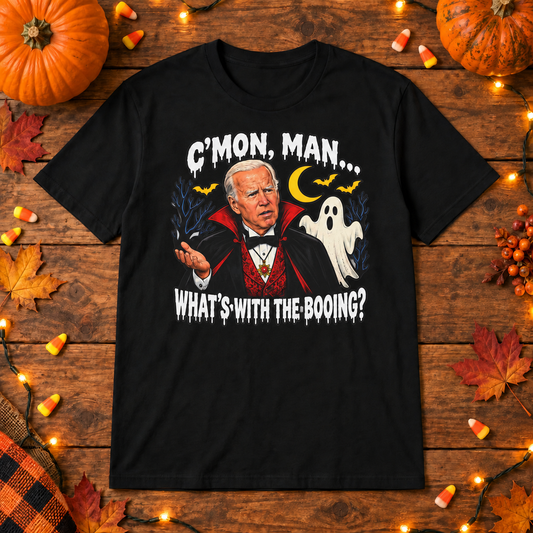 Black Joe Biden whats with the booing shirt on a wooden background with Halloween lights, pumpkins and candy