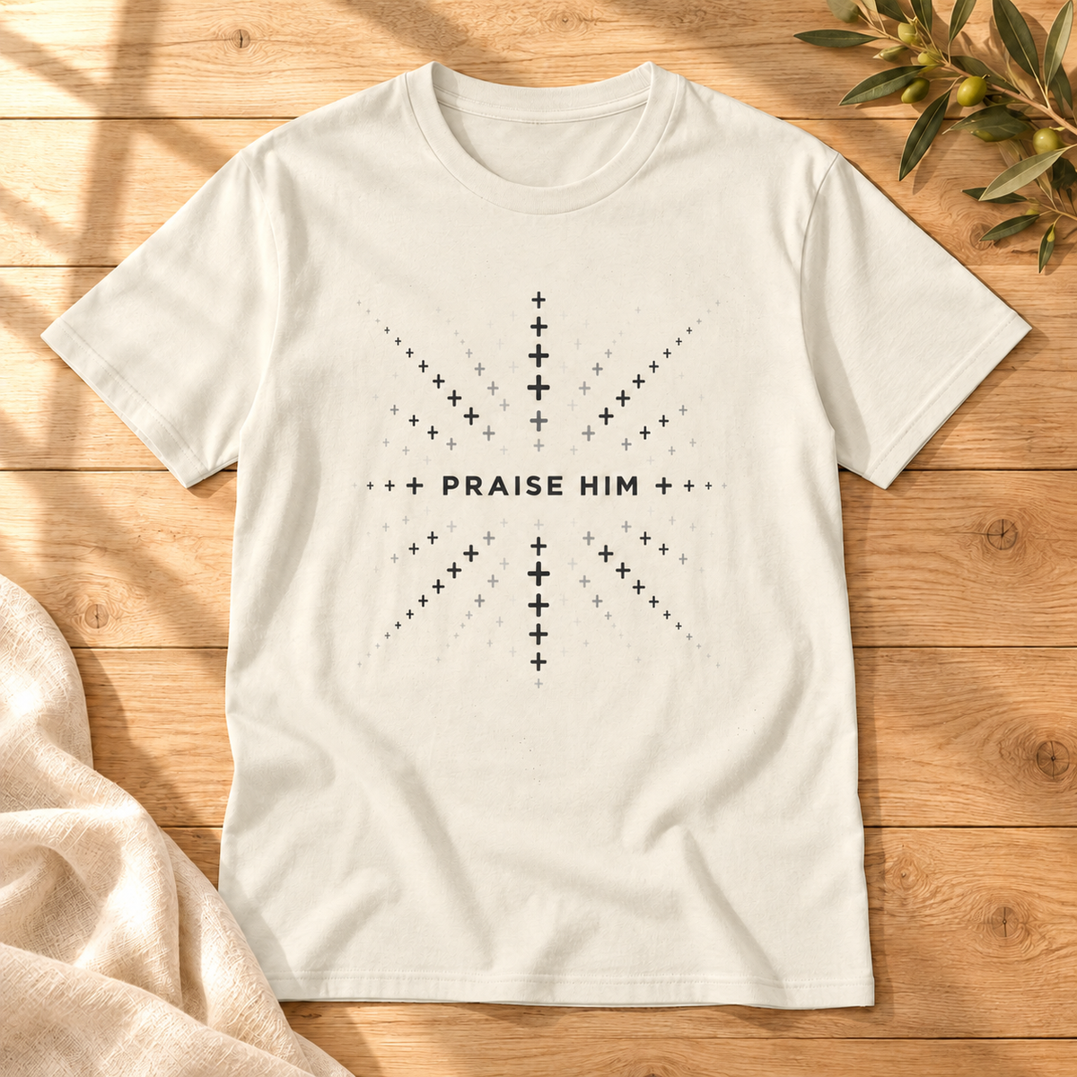 Praise Him T-shirt in Natural on sunlit oak with cream linen and an olive sprig