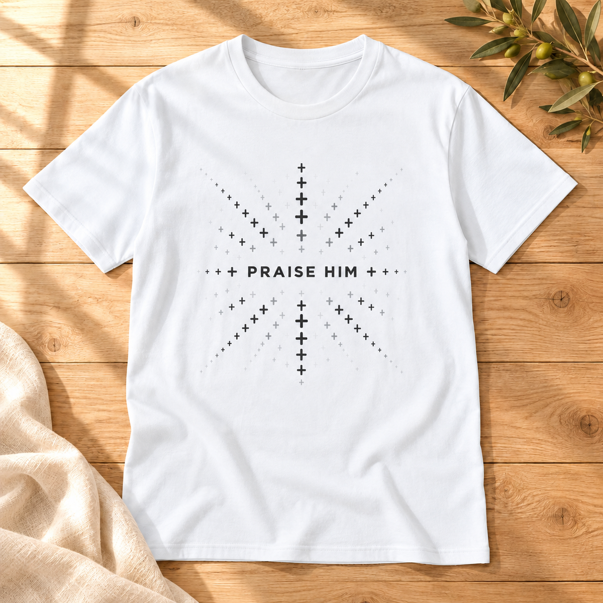 Praise Him T-shirt in White on sunlit oak with cream linen and an olive sprig
