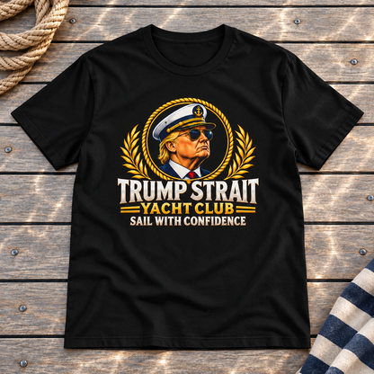 Trump Strait Yacht Club T-shirt in Black on a styled teak yacht deck with rope and striped linen