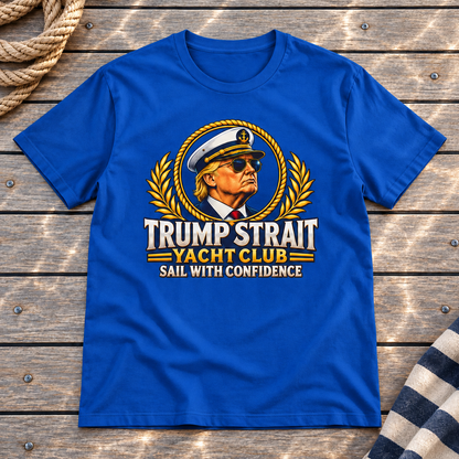 Trump Strait Yacht Club T-shirt in Royal Blue on a styled teak yacht deck with rope and striped linen